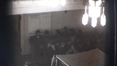 1941: crowd bustles through large room in fancy dress near tents NEW YORK