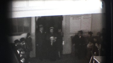 1941: a man and two women exiting a building and walking towards a vehicle NY