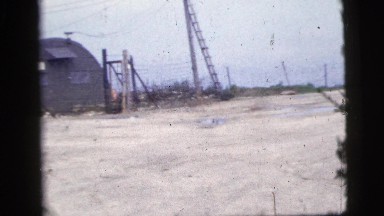 1956: abandoned army camp, buildings are warn, and there are no signs of life.