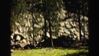 1967: a beautiful blue sky above a beautiful rugged mountain peak as seen pine