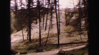 1967: a beautiful desert and rugged hillside with a cloudy sky above WYOMING