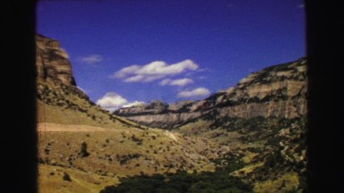 1967: a beautiful desert and rugged mountain ridgeline with a bright blue sky