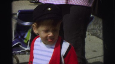 1972: Boy Holding Stick Stands Next to Wheelchair in Lynbrook, New York