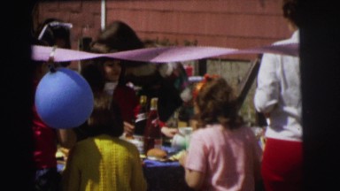 1972: a lot of children having food from the table at a party LYNBROOK, NEW YORK