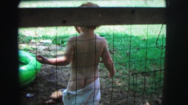 1972: child behind fence has exposed rear; plays near pool anyway LYNBROOK