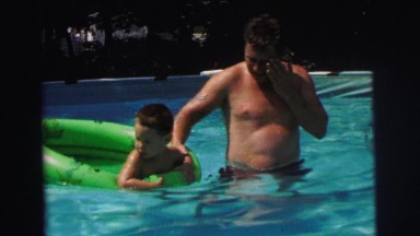 1972: man and boy in swimming pool LYNBROOK, NEW YORK
