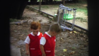 1972: two kids in similar dress is playing before a camera LYNBROOK, NEW YORK