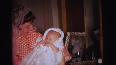 1972: a baby wearing a beautiful dress in baptism ceremony day LYNBROOK