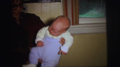 1972: home video of baby being picked up and sleeping on chair LYNBROOK