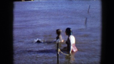 1959: swimming with the family members and pet is full of fun and happiness