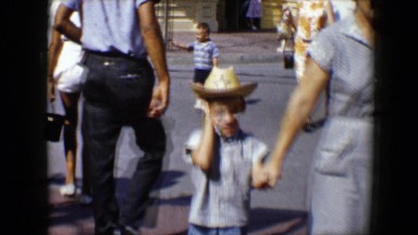1959: families walking through an amusement park featuring a train DISNEYLAND,