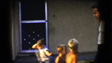 1959: woman is playing with some boys standing beside a man DISNEYLAND,