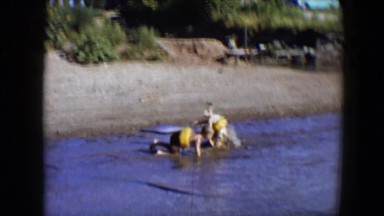 1959: kids splash and play in a lake DISNEYLAND, CALIFORNIA