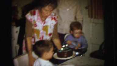 1972: A Family Gathered Around a Table as the Birthday Boy Prepares to Blow Out Candles