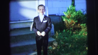 1972: young boy in his fancy tuxedo makes funny face outside home LYNBROOK