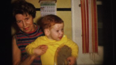 1972: the women playing with a kid makes them smile LYNBROOK, NEW YORK