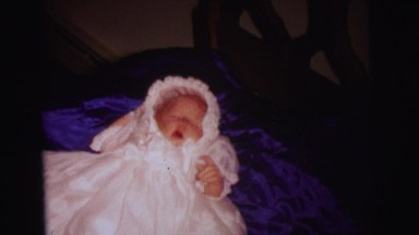 1972: a baby and a toddler in bed lying on a blue comforter LYNBROOK, NEW YORK