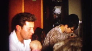 1972: a family gathered around a dining room table enjoying dinner together