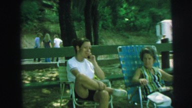 1972: stranger films young girl at picnic park sitting with an elderly woman
