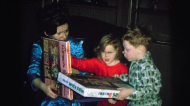 1972: childrens are playing with his mother using books LYNBROOK, NEW YORK