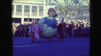 1948: Clowns Carry Large Yellow Bird in Cracked Egg, Marching Band Follows