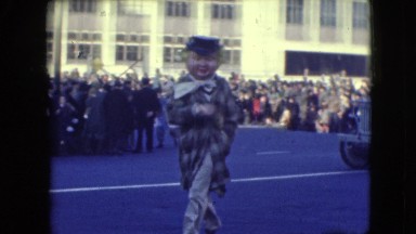 1948: onlookers enjoy the city parade from the sidelines sitting on the curb