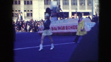 1948: showy and spectacular pageantry moving along the road through crowd