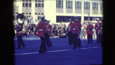 1948: marching band holds horns at the ready while marching in parade BALTIMORE,