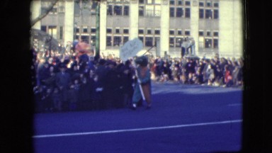 1948: clown leads parade followed by giant nutcrackers clumsy roaming around