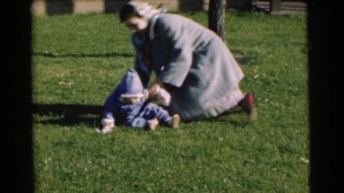 1951: A Mother Wrestling With Her Baby In The Front Yard In Chatham, New Jersey