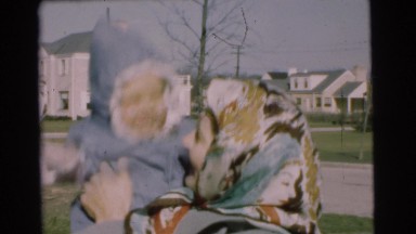 1951: woman bounces a baby in the middle of a neighborhood CHATHAM, NEW JERSEY