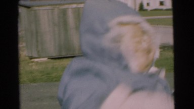 1951: happy mother bouncing happy baby outside in winter CHATHAM, NEW JERSEY