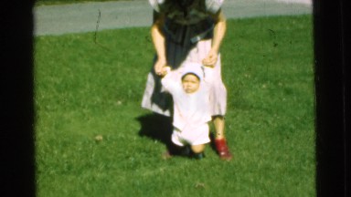 1951: woman helping small child walk CHATHAM, NEW JERSEY