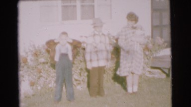 1951: a man and children dressed in plaid jackets walking in the street CHATHAM,