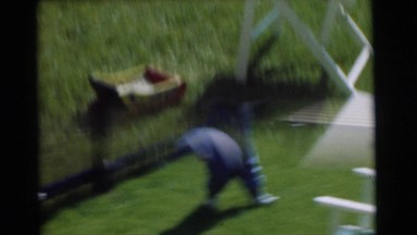 1951: two toddlers, one in blue and the other in yellow, happily playing outside