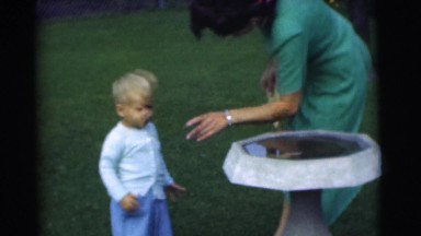 1951: mom dressing her young kids. CHATHAM, NEW JERSEY