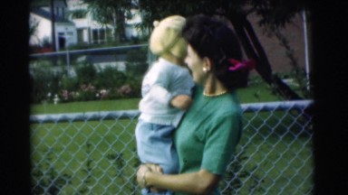 1951: a pretty young mom outside holding her baby CHATHAM, NEW JERSEY