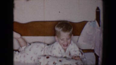 1958: blonde boy playing in bed TUCSON, ARIZONA