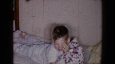 1958: the boy playing on bed with the magical pillow go crazily TUCSON, ARIZONA