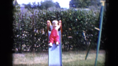 1958: little boy sliding down the slide TUCSON, ARIZONA