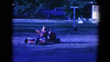 1958: child having fun driving red go kart in yard TUCSON, ARIZONA