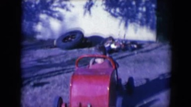 1958: two young children playing with a car and a swing in a playground TUCSON,
