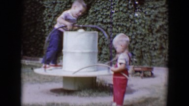 1958: small children playing with mini-roundabout TUCSON, ARIZONA