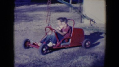 1958: two kids are driving a play car in a children's park TUCSON, ARIZONA