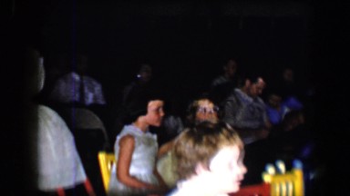 1958: a young girl with a book to her chest rising from her chair TUCSON,