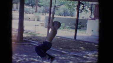 1958: boy swings from a rope on a tree TUCSON, ARIZONA