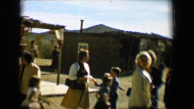 1958: a group of women and children standing outside