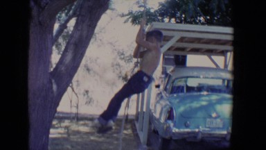 1958: a two childrens are playing with roop with fix a tree TUCSON, ARIZONA