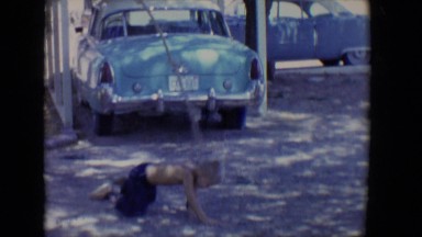 1958: little boy on rope swing hits the ground in driveway TUCSON, ARIZONA