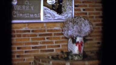 1958: christmas decoration display outside in front of a traditional brick home